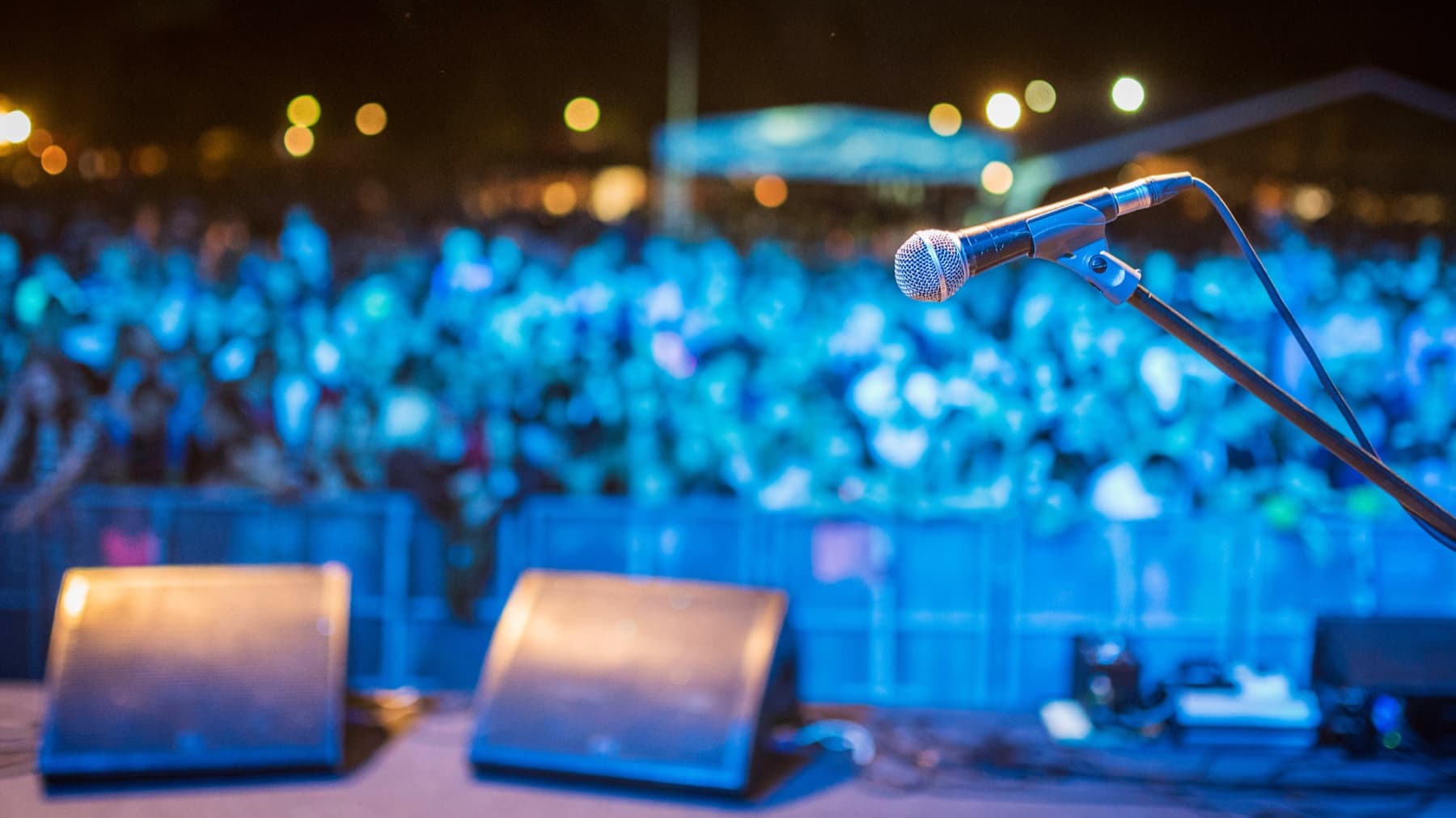 Mic stand at soundcheck, crowd in the distance